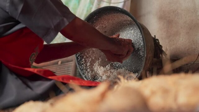 Activities of coconut grating in asian market. Preparing coconut flakes using machine. Grating coconut for making coconut milk