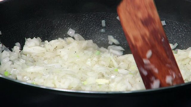 Onions being saut&eacute;ed in a pan
