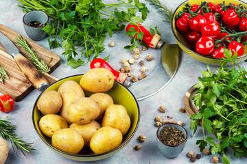 Raw potato and red tomatoes on a table