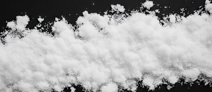 Abstract white snow texture on black background with soft fluffy details centered horizontally creating a striking contrast for overlays.