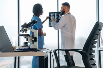 Fototapeta premium Against window, with x-ray. Doctors are in the clinic