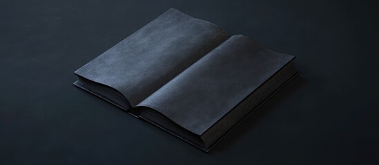 Open black book with blank pages positioned centrally on dark textured surface, creating contrast and space for text or additional graphics.