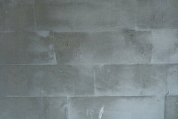 Concrete wall texture with subtle marks and varied shades in daylight
