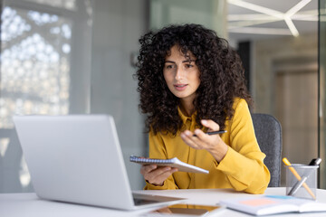 Successful woman with notebook in hands watching video course, online business meeting conference....