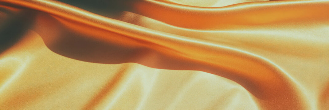 Luxurious gold suede fabric with smooth texture and subtle sheen creates warm shadows