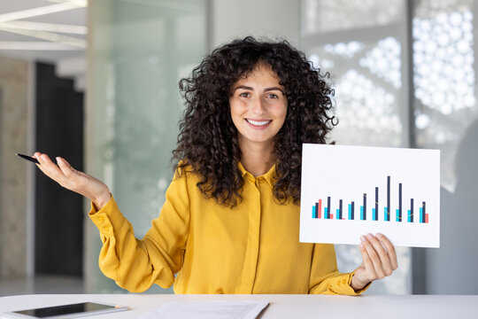 Webcam view, woman smiling and looking into camera, showing financial investment presentation, income graph and charts. Businesswoman at business meeting, remote conference.