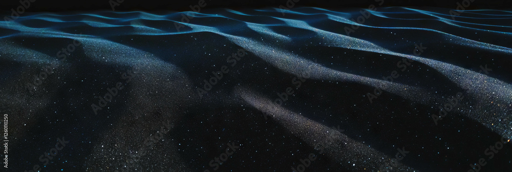 Poster texture of black sand with fine grains creating gentle ripples under soft lighting