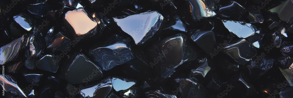 Aufkleber captivating texture of black sand featuring sharp obsidian fragments reflecting light