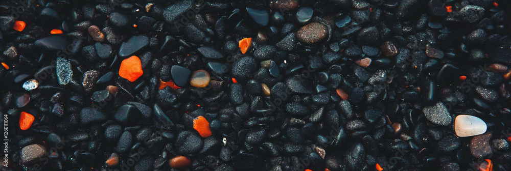 Poster exploring the unique texture of black sand mixed with varied pebbles on the beach