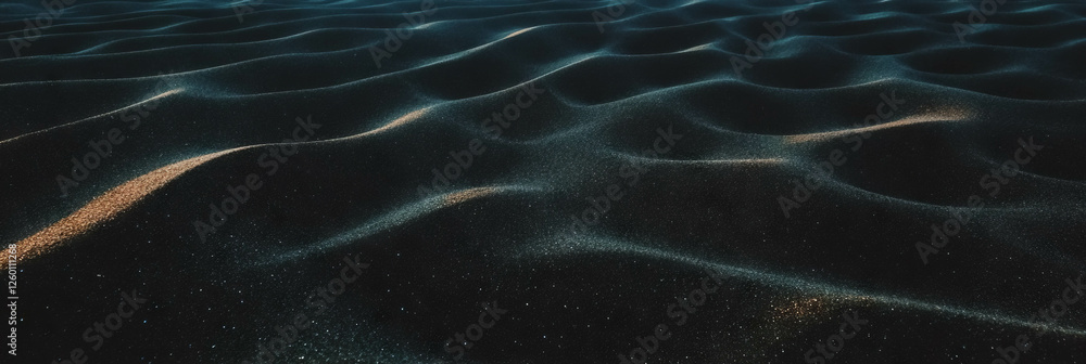 Poster Textured black sand with windblown patterns illuminated by soft light