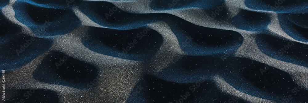 Poster exploring the soft texture of black sand mixed with fine ash along a coastal area