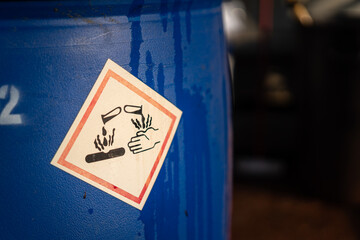 Acidity corrosion or skin burn hazard, safety sign on the chemical containment barrel. Sign and...