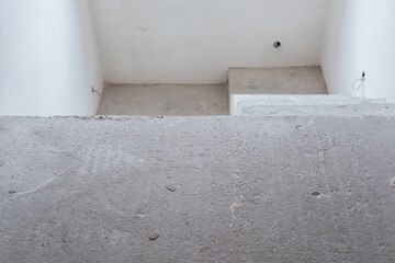 Concrete stairwell interior with minimalistic design and white walls