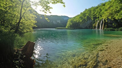 Fototapeta premium Crystal-clear lake, waterfalls, lush forest, sunny day, nature travel
