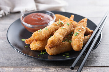 Breaded Torpedo shrimps on wooden table