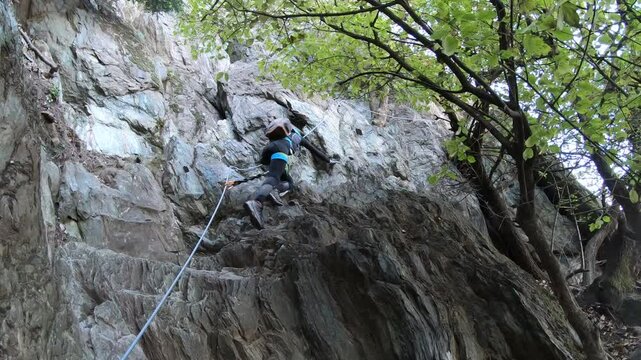 Female Climber On Via Ferrata Carlo Giorda alla Sacra di San Michele. Piedmont, Torino