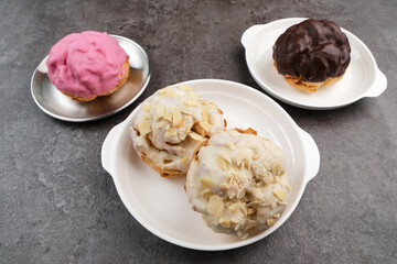 Kue Soes or Choux Pastry Cream Puffs filled with chocolate or vanilla whipped cream
