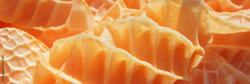 Aufkleber crispy golden cone wafers with uneven diamond grid texture shining in sunlight