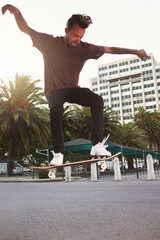Skateboard, city and man with ollie trick in air for jump stunt, practice and energy in New York....