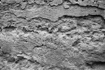 Texture of weathered concrete wall with intricate patterns and shadows