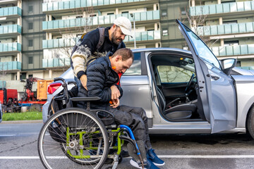 Caregiver helping disabled person entering car in city street