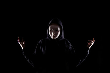 Hooded Figure Wearing a White Mask in Dark Lighting