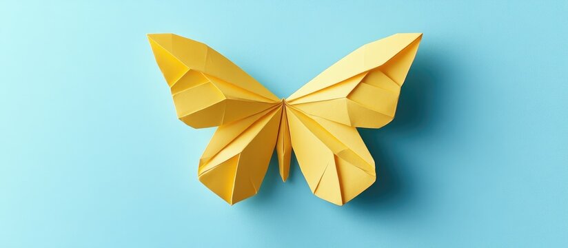 Step by step photo collage of origami butterfly creation on light blue background with vibrant yellow paper butterfly positioned centrally