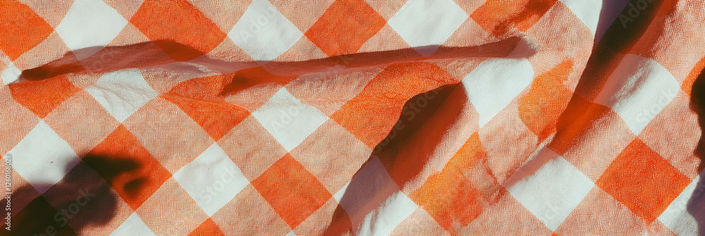 Poster textured orange checkered tablecloth with large squares and crisp fabric detail