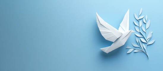 White paper origami dove with olive branch positioned on the right side against a soft blue background representing peace and tranquility.