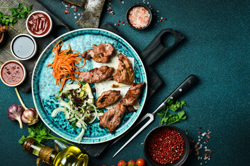 Grilled turkey kebab with onions and pita bread. Azerbaijani cuisine. Free space for text. Close up.