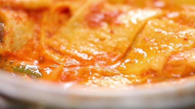 Adding vinegar to spicy codfish soup