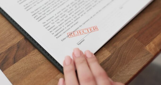 Businesswoman rejects contract document stamping paper with red seal. Lawyer signals official disapproval of business agreement in office