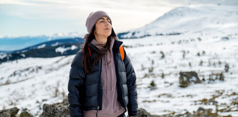Relaxed woman breathing fresh air in a snowy winter mountain	
