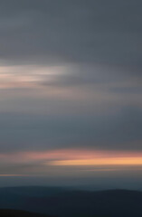 Softly blurred natural background creating a serene atmosphere at dusk near a mountain range