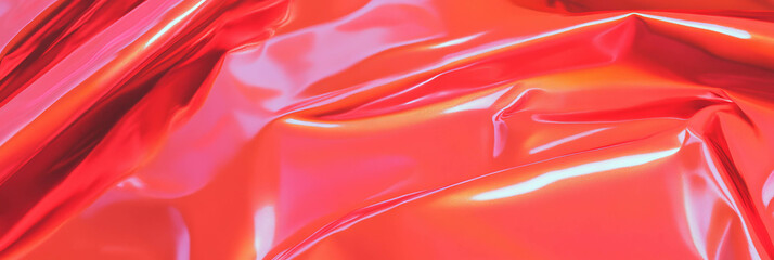 Bright shiny vinyl fabric showcases a vibrant red texture with dynamic light reflections