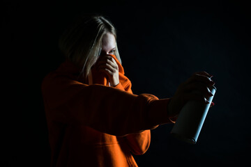 Mysterious Woman Holding Spray Paint Can in Low-Key Lighting