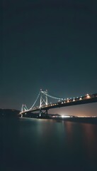 Obraz premium a nighttime view of a large suspension bridge.