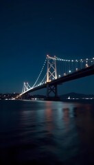 Fototapeta premium a nighttime view of a large suspension bridge.