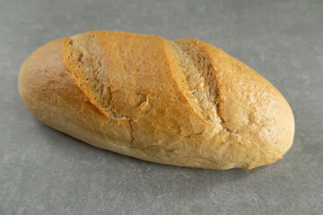Loaf of bread on a gray background.
