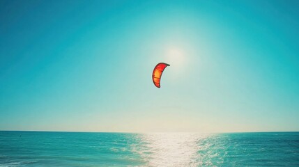 Vibrant photo of a kiteboarding scene on a sunny day. Clear blue sky and calm water creating a thrilling atmosphere. Emphasizing sport and freedom. Perfect for water sports and adventure content.
