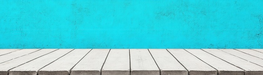 Fototapeta premium A minimalist setting featuring a turquoise wall and a wooden floor, creating a vibrant backdrop for various creative uses.