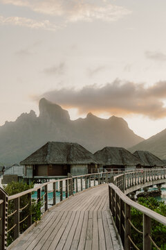 A winding boardwalk leads to dreamy overwater bungalows kissed by the golden sunset and framed by majestic peaks. Serenity luxury and island magic all in one breathtaking escape in Bora Bora