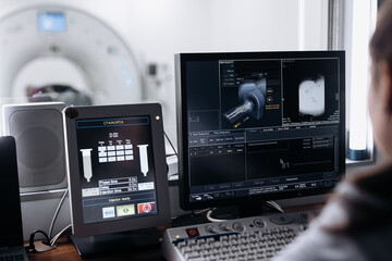 Young woman doctor, healthcare professional using computer, look at device screen, reviewing...