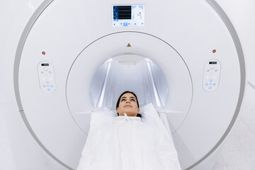 Female finished magnetic resonance imaging, Patient is moving out of MRI scanner capsule. Woman...