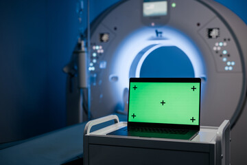 Computed tomography scan, green mock-up on laptop. Medical research environment software with CT...