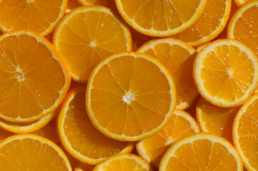 Brightly colored orange slices create a vibrant, juicy display on a sunny day