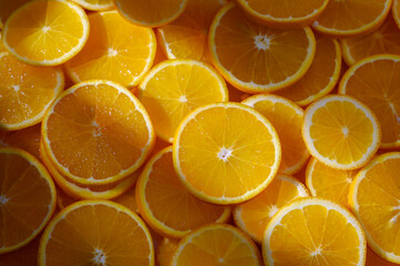 Freshly sliced oranges create a vibrant and sunny display of citrus delight in a rustic kitchen
