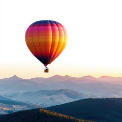 A vibrant hot air balloon floats over scenic mountains at sunrise, showcasing a stunning blend of colors against the sky.