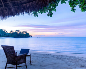 Fototapeta premium Remote work. Chair and laptop on beach at sunset. Holiday. Relaxation