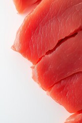 A close up of a piece of red meat. The meat is sliced and has a lot of texture